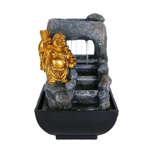 A golden Laughing Buddha statue sitting atop a black fountain with water flowing from the top, set against a gray background.