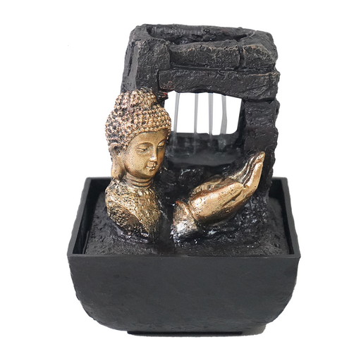 A black fountain featuring a gold-colored statue of the Buddha with water flowing over his hand, set against a simulated rustic backdrop.