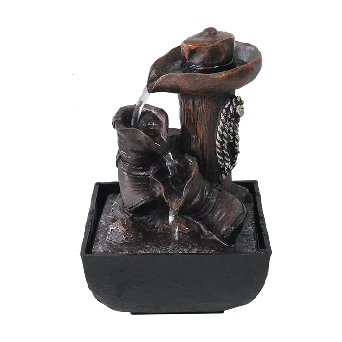 A rustic water feature fountain with a cowboy hat as the source and a weathered boot as the receiver, set in a black base.