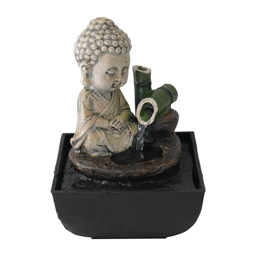 A Zen-inspired water feature with a sculpture of a meditating Buddha and a bamboo stem from which water is cascading.