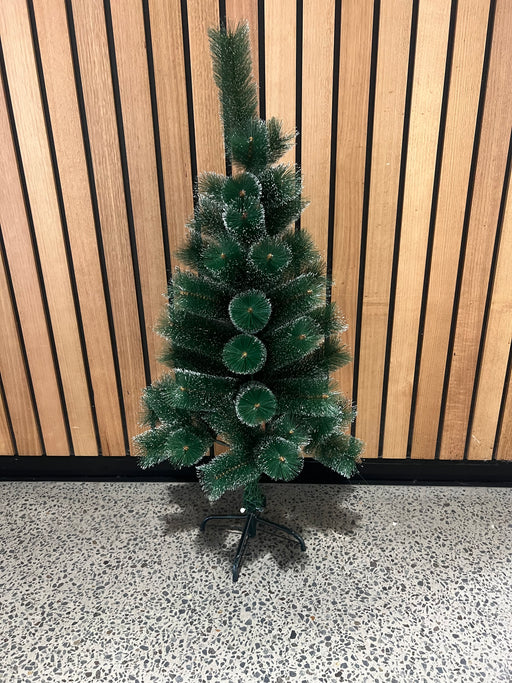 White-tipped pine Christmas tree in living room setting