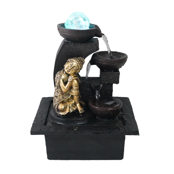 A Zen-inspired water feature with a meditating Buddha figure, a large blue sphere at the top, and water flowing over a black base.