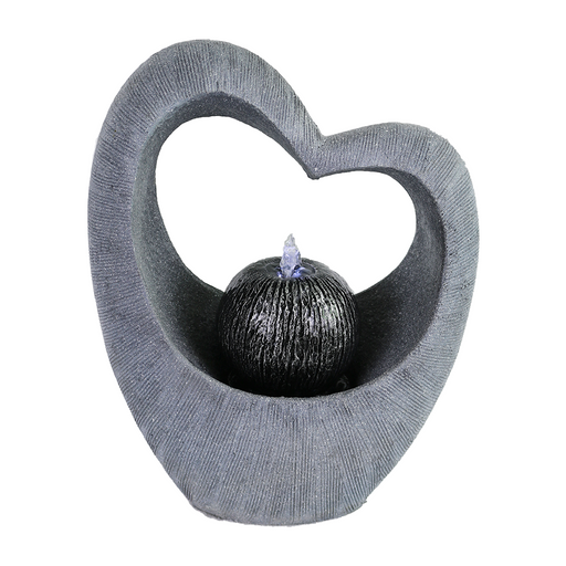 A heart-shaped water fountain made of concrete with a sleek, contemporary design, featuring a small floral decoration at the center.