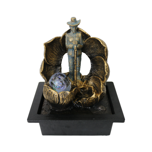 Decorative fountain with a cowboy figure and shell design on a white background