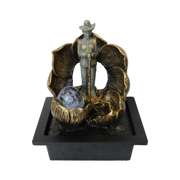 Decorative fountain with a cowboy figure and shell design on a white background