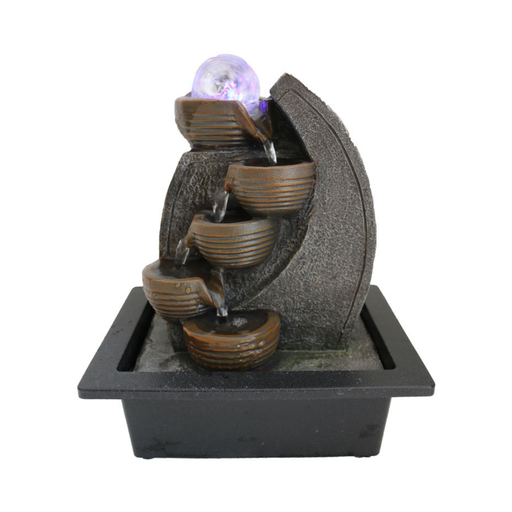 Decorative water fountain with LED light on a white background