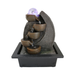 Decorative water fountain with LED light on a white background