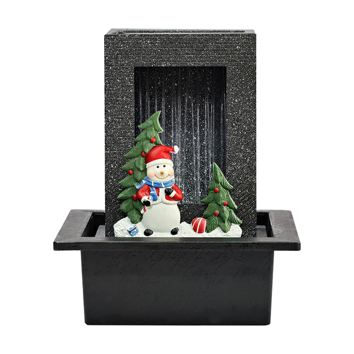 A holiday-themed water fountain featuring a snowman and Christmas trees on a black base, with a textured backdrop.