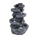 A modern Zen-inspired water feature with tiered rocks and a gentle flow of water, featuring sleek, contemporary design.